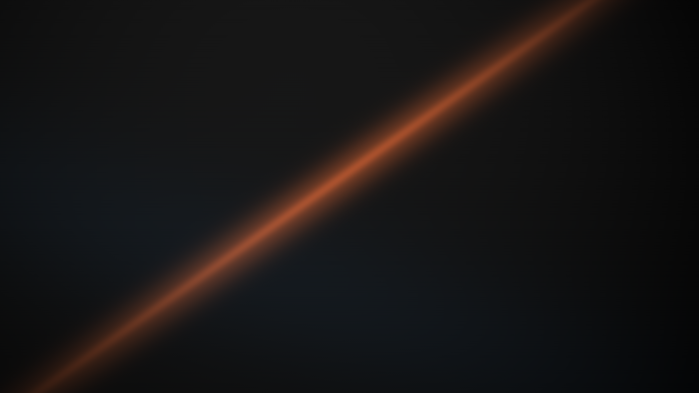 A single narrow shaft of warm amber light raking across a dark industrial surface